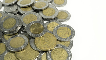 Mexican pesos, old and damaged Mexico coins on white background, editorial and illustrative image.