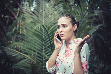 Beautiful women are communicating via phone. She has a way of expressing her displeasure and doubt. Vintage Style. Copy space.