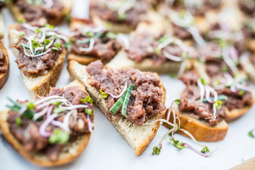 Raw Beef tartar mini breads on a catering table at event