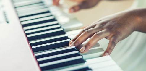 Close-Up a black woman hands playing on piano