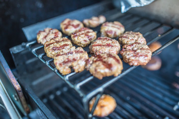 Close-up fresh grilled mini burgers on party in garden