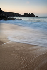 Fototapeta na wymiar Stunning vibrant sunrise landscape image of Porthcurno beach on South Cornwall coast in England