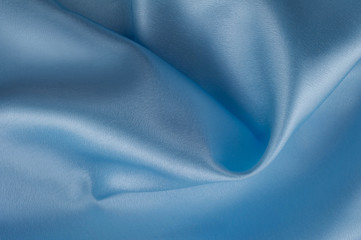 Abstract silk luxury background, piece of cloth, light blue cloth texture.