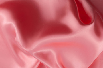 Abstract silk luxury background, piece of cloth, light pink cloth texture.