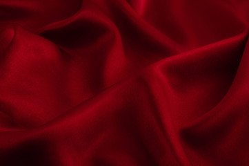 Fototapeta premium Abstract silk luxury background, piece of cloth, deep red cloth texture