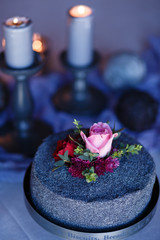 Luxury dinner set up table. Loft style dinner table concept. Poppy cake in the foreground