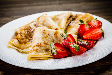 Crepes with cream and strawberries