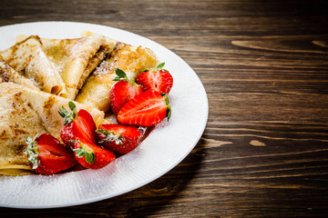 Crepes with cream and strawberries