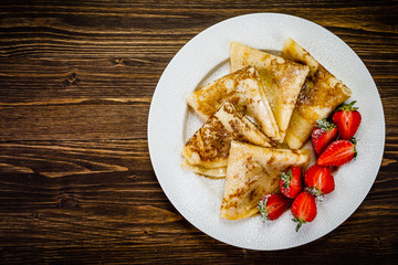 Crepes with cream and strawberries