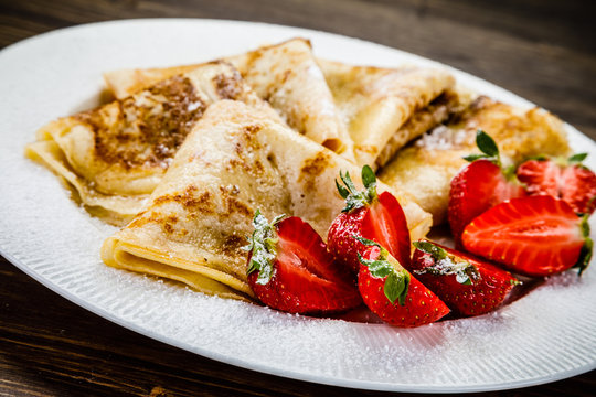 Crepes with cream and strawberries