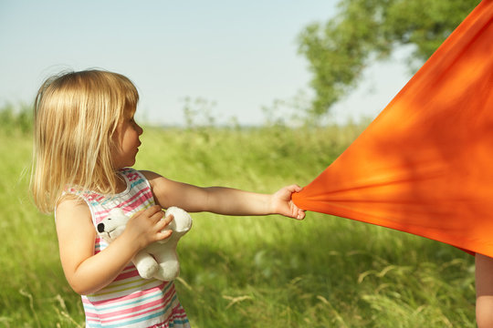 Child Is Pulling A Dress For Her Mother