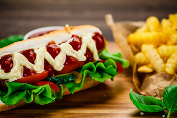 Hot dog and french fries on cutting board