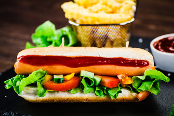 Hot dog and french fries on cutting board