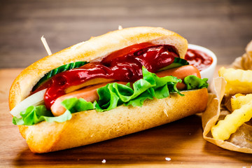 Hot dog and french fries on cutting board