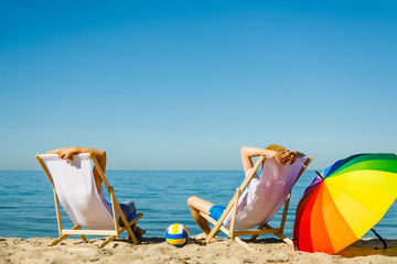 Woman and man relaxing on beach