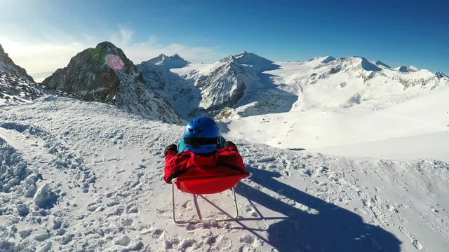 Young skier enjoying view to Adamello glacier, Tonale, Italy