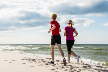 Woman and man running on beach