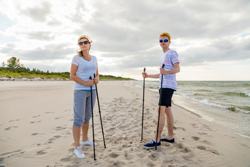 Nordic walking - man and woman training on beach