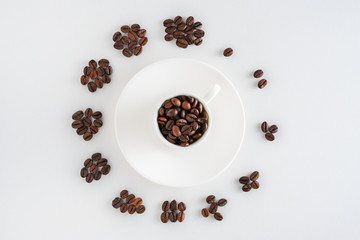 cup of coffee on saucer and coffee beans in form of a clock