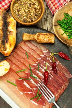 Thinly sliced German black forest ham with sliced ciabatta bread. Sliced and smoked ham with schwarzwald ham or prosciutto. Traditional German food.