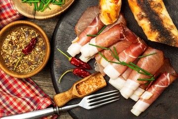 Thinly sliced German black forest ham with sliced ciabatta bread. Sliced and smoked ham with...