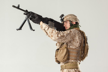 Soldier in camouflage holding rifle