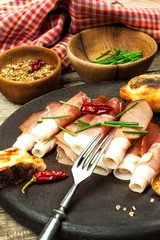 Thinly sliced German black forest ham with sliced ciabatta bread. Sliced and smoked ham with...