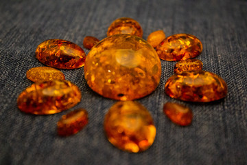 Artificial transparent amber cabochons on a black background closeup