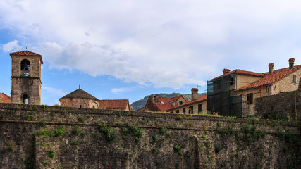 View to the city wall and roofs of old historical buildings in the ancient town of Kotor at Montenegro