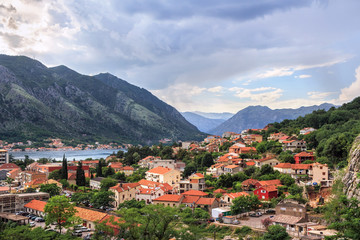 Naklejka na ściany i meble Panoramic view from above on the old city Kotor, bay in Adriatic sea and mountains in Montenegro at sunset time, gorgeous nature landscape