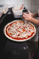 Close up shot of pizza making or preparing process