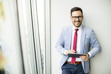 Fototapeta premium Young businessman with digital tablet in office