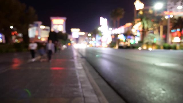 Timelapse of people walking through Las Vegas at night out of focus