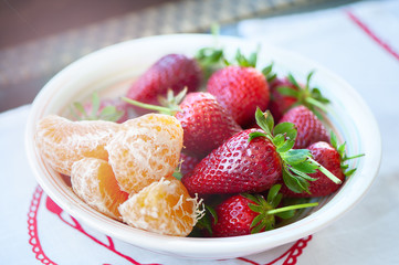 Plate with strawberries and tangerines .Fruit, Useful food