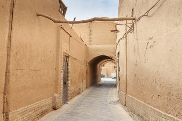 Narrow street with arches of old town in Yazd. Iran