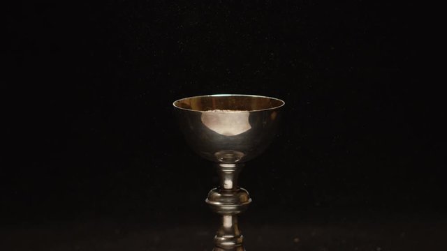 Chalice full of wine slow motion pour 