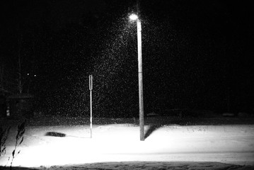 Evening snowfall and the streetlamp