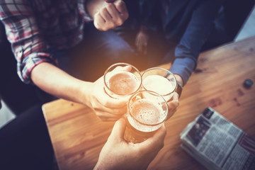 businessteam relaxing and talking in nightclub ; businessman drinking beverage in counter at nightclub