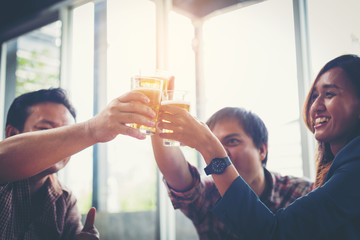 businessteam relaxing and talking in nightclub ; businessman drinking beverage in counter at nightclub