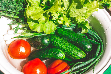 Various fresh vegetables in a pot - colorful fresh clear spring soup. Rural kitchen scenery from above top view