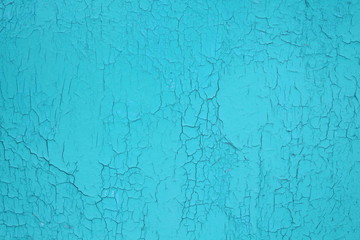 The chipped sheet of plywood is blue. Close-up. Background. Texture.