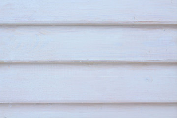 White boards superimposed on each other. The wall of the house. Close-up. Background. Texture.