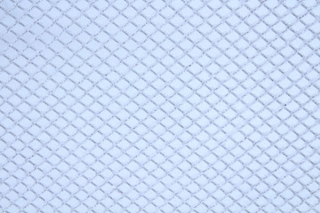 Naklejka premium The fence of the grid is covered with snow. Close-up. Background. Texture.