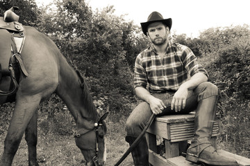 Fototapeta na wymiar Handsome cowboy, horse rider on saddle, horseback adn boots