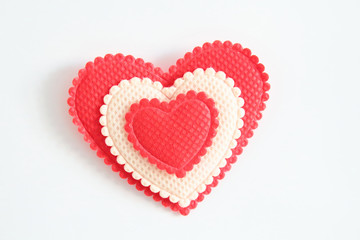 Beautiful heart made of fabric on a white background. Close-up. Background. Texture.