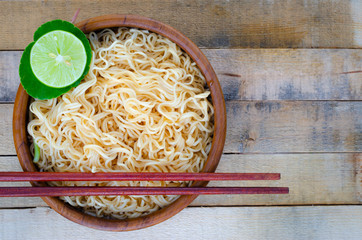 Instant noodles in wooden cup on wood background, Top view,Thai food style,  junk food concept.