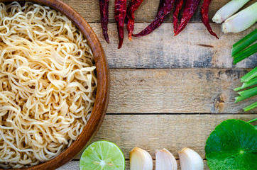 Instant noodles in wooden cup on wood background, Top view,Thai food style,  junk food concept.