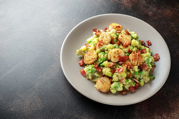 Fried scallops with mash potato, green peas and bacon