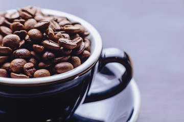 closup coffee cup full of coffee beans