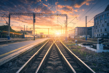 Railway station and beautiful colorful sky at sunset. Industrial landscape with railroad, blue sky...
